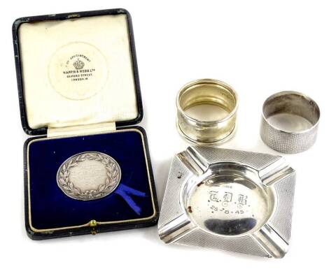 A collection of small silver, to include two napkin rings, an ashtray with engine turned decoration and inscription to centre, T.D.B.? 25-8-45, Birmingham 1917, and a Hackney Horse Society Doncaster Show 1924 medal, marked to reverse The Presidents Medal 