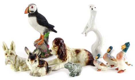 A collection of ceramic animals, to include a seated Sylvac dog, a Russian weasel or ferret, Beswick type ducks, Country Artists puffin, a Goebel hippo, etc.