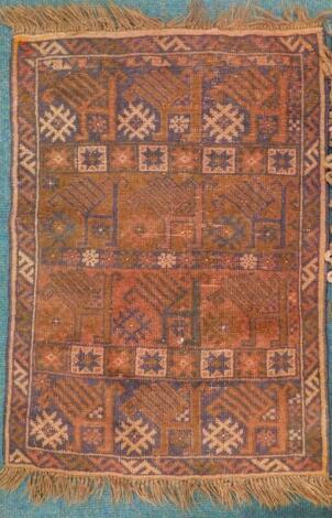 A Turkoman type rug, with a geometric design, on a brown ground, 114cm x 82cm.