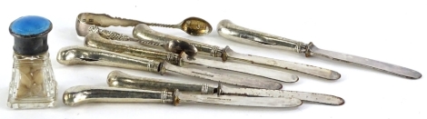 A collection of silver and silver mounted items, to include a pair of sugar tongs, a set of six pistol handled dessert knives with stainless steel blades, and a cut glass jar with silver enamelled lid.