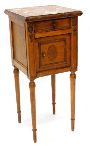 A French oak bedside cabinet, with a red varigated marble top, above a frieze drawer and a panelled door, on turned tapering legs, 83cm high, 38cm wide,