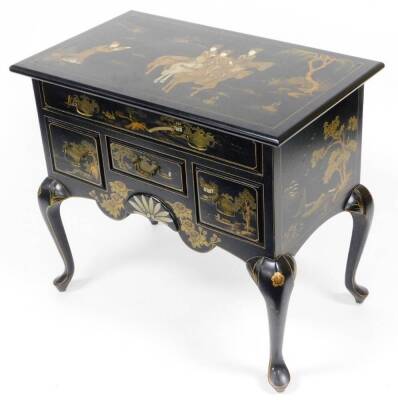 An early 20thC Oriental style black lacquer lowboy, decorated with gold figures on horseback with trees, flowers and sprays, with one large drawer, three smaller drawers, on splayed feet, 76cm high, 86cm wide, 51cm deep.