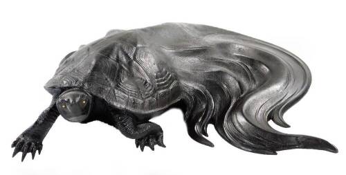A fine Japanese iron okimono of a minogame (mythical turtle) with swirling hairy tail, signed Ryubundo, 25cm wide. The renowned Ryubundo family specialized in fine iron work, particularly water kettles (tetsubin) often used in tea ceremony. They began cre
