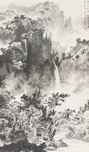 A 20thC Chinese ink painting, of a dramatic rocky mountainous landscape, inscribed in the upper right corner,red seals to the lower, 105cm x 64cm.