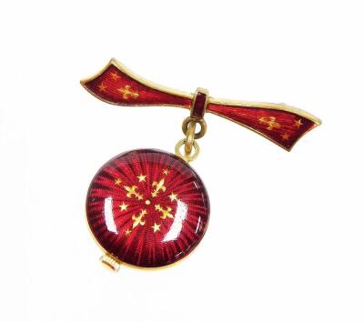 A Verity fob watch, with bow brooch top and small fob watch base, with red enamel and gilt decoration, on a gilt metal brooch back, the watch 2cm diameter. - 2