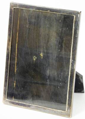 A 20thC photograph frame, of plain rectangular form with ebonised oak easel back, marked P. PAT25474, white metal, unmarked, 20cm high, 15cm wide. (2)