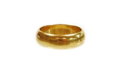 An 18ct gold wedding band, of plain design, hallmarks rubbed, ring size J½, 5.8g all in.