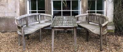 Withdrawn Pre-Sale by Vendor. A hardwood garden suite, comprising two curved serpentine benches and lath top rectangular table, 150cm x 70cm.