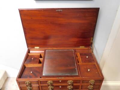 A George IV mahogany enclosed dressing table, the rectangular top with a moulded edge enclosing a fitted interior with a central adjustable mirror and various lidded compartments and recesses, the front with an arrangement of seven false drawers and doubl - 4