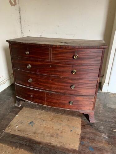 A Regency mahogany bow front chest, of two short and three long drawers with some knob handles and splay feet, 99cm high, 105cm wide, 60cm deep. (AF-condition poor as illustrated and missing back leg)