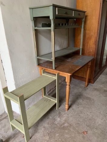 A pine kitchen table, 107cm x 69cm, a similar width side table with wine rack and a shelf unit. (3)