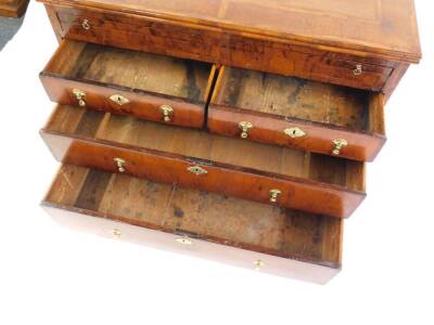 A William & Mary and later walnut bachelor's chest, of two short over two long drawers, with brushing slide and feathered cross banding, with a quarter veneered top, raised on bracket feet, 76cm high, 73.5cm wide, 53.5cm deep. - 11