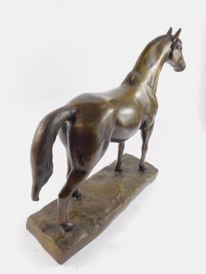 A filled bronze figure of a horse, modelled in standing pose, raised on a naturalistic rectangular base, 37cm high, 44cm wide. - 2