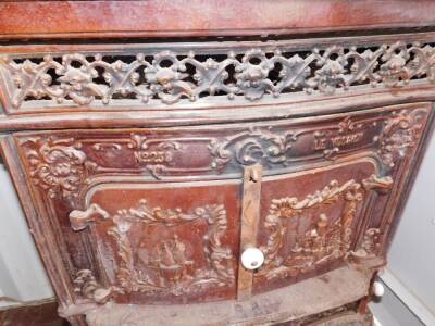 A French late 19thC cast iron and enamel wood burning stove Le Vosgien, No 258, by De Dietrich & Cie., Niederbronn., of serpentine form, the front and sides with a pierced grill moulded with cherubs' heads, the two doors and side panels moulded with castl - 2