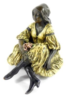 After Franz Xaver Bergmann (Austrian, 1861-1936). A cold painted bronze figure of a lady modelled in seated pose, with a bunch of roses, having a risque underside, bears marks, 11.5cm wide.