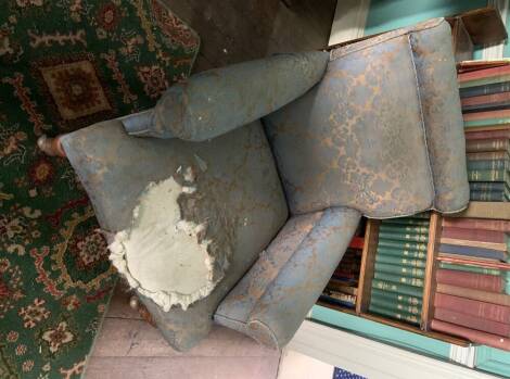 A late Victorian upholstered armchair, in blue silk damask, on turned legs and later castors, 90cm high.