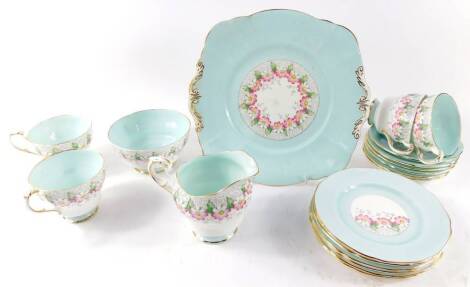 A Paragon porcelain tea service, decorated with flowers against a turquoise ground, pattern no. G5951., printed and painted marks, comprising bread plate, cream jug, sugar bowl, four cups, six saucers and plates.