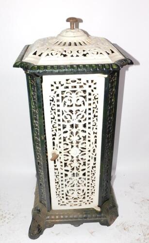 A French early 20thC cast iron and enamel conservatory heater, of canted square form with pierced foliate panels, raised on scroll feet, 95cm high, 44cm diameter. (AF)