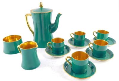 A Carlton ware early 20thC green and gilt coffee service, comprising coffee pot, cream jug and sugar bowl, five demi tasse cans and saucers.