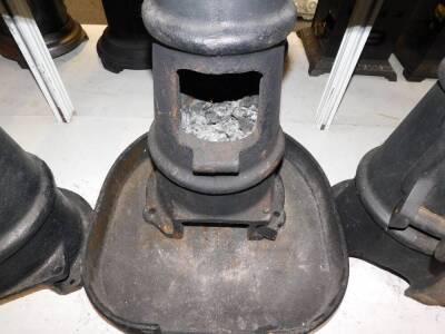 Three cast iron multi fuel burners, of chimney form, one with a base stand, 48cm high. (4) - 3