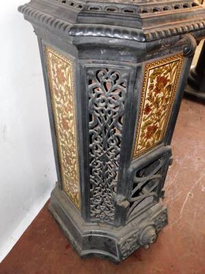 A French late 19thC cast iron and enamel Goudin stove, by Dequenne & Cie., of canted square form with pierced foliate panels, alternating with panels inset with floral pottery tiles, model no 78., 91cm high, 45cm diameter. - 3