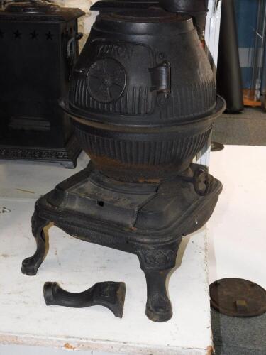 A Masport Yukon late 19thC cast iron pot belly stove, of fluted globe form, raised on an iron base and three cabriole legs, 58cm high, 34cm diameter.