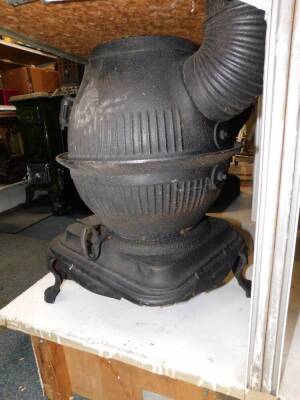 A Masport Yukon late 19thC cast iron pot belly stove, of fluted globe form, raised on an iron base and three cabriole legs, 58cm high, 34cm diameter. - 4