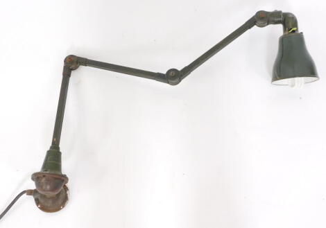 A early 20thC vintage Invisaflex industrialist wall mounted angle poise type lamp, painted in green.