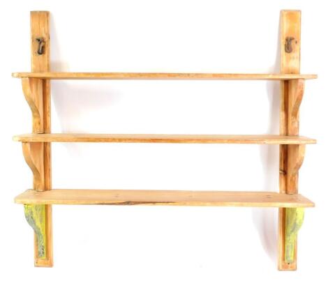 A set of three Victorian pine scullery shelves, with shaped end supports, 149cm high, 158cm wide.