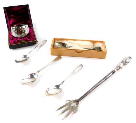 A Victorian silver napkin ring, cased, Birmingham 1898, an Edward VII toasting fork with silver handle, embossed with cherubs' heads, Birmingham 1904, three silver teaspoons and a commemorative teaspoon commemorating Edward VII, 3.52oz all in.