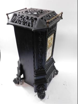 A cast iron heater, containing bottle gas, of canted square form, raised on ball and claw feet, 91cm high, 41cm wide. - 4