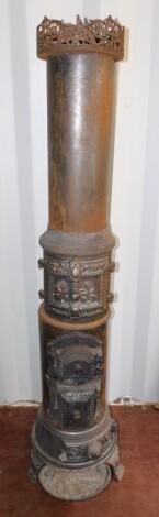 A Jernstoberi of Frederiksberg late 19thC cast iron wood burning stove, of cylindrical form, with three decorated cast doors and an ashes drawer, raised on three shaped feet, 180cm high, 36cm diameter. (AF)