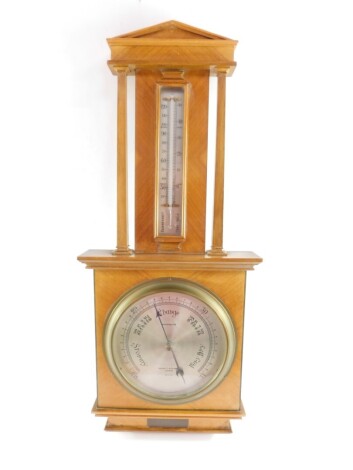 A mid 20thC walnut cased barometer by Negretti & Zambra, London, R/3313, with thermometer, the case of architectural temple form, with presentation plaque, 71.5cm high, 30cm wide.