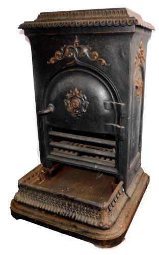 A French cast iron late 19thC stove, with a hinged lid, rectangular body and shaped hearth with pierced fender, 76cm high, 46cm wide, 31.5cm deep.