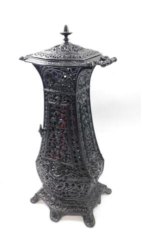 A Victorian cast iron cathedral heater, of twin handled baluster form, with pierced and embossed decoration of masks, fruit and foliate scrolls, 76cm high, 34cm wide, 24cm deep.