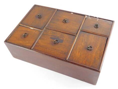 A Georgian mahogany spice box, of rectangular section, with six staggered and vary sized drawers, with brass ring handles, 9cm high, 30cm wide, 20cm deep.