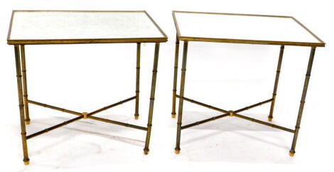 A pair of brass rectangular occasional tables, each with a mirrored top etched with Chinoiserie designs, on turned supports with 'x' shaped stretcher, 51cm high, 54cm wide, 39cm deep.