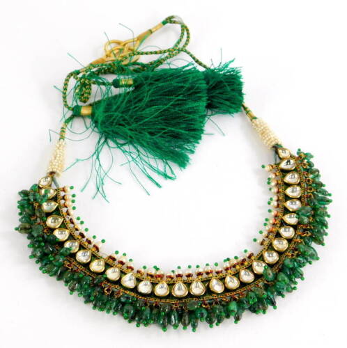 An Indian dress necklace, made up of various rectangular enamelled panels, the front set with seed pearls and clear paste stones, with jade beaded drops, with red and green enamel decoration, on a cream red and green enamel flower back, yellow metal unmar