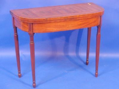 A George III mahogany and cross banded fold over card table with plain