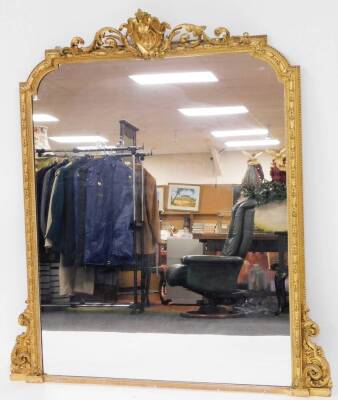 A late 19thC gilt gesso overmantel mirror, with a scroll crest and leaf moulded frame, 153cm high, 120cm wide, 6cm approx deep.