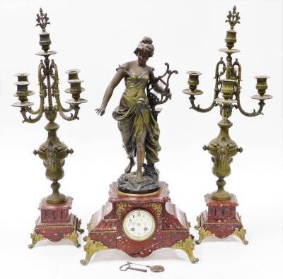 A late 19thC French clock garniture, with mantel clock, on a red marble base with a gilt spleter figure of a maiden with a harp to top titled Harmonie, with a cream coloured floral dial, 8cm wide, eight day chiming movement, on rococo style feet, with two