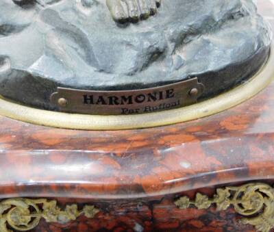 A late 19thC French clock garniture, with mantel clock, on a red marble base with a gilt spleter figure of a maiden with a harp to top titled Harmonie, with a cream coloured floral dial, 8cm wide, eight day chiming movement, on rococo style feet, with two - 6