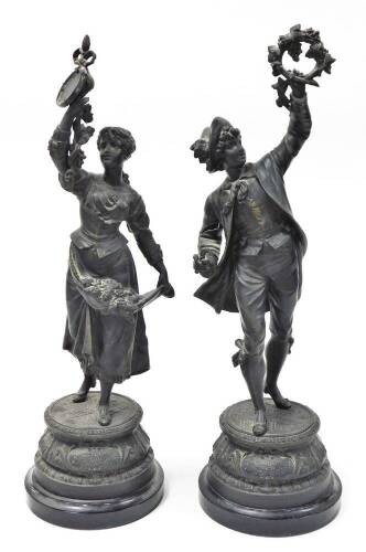 A pair of late 19thC spelter figures, a young lady and gentleman, each with grape vines and flowers, on a stepped base stamped Retour des Vendanges, 56cm high.