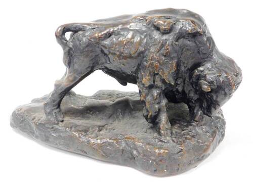 A modern bronzed resin sculpture of a bison with head down, on rustic base, 22cm high.