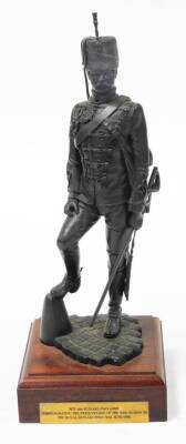 A bronze painted regimental resin figure of a sergeant of 11th Hussars c1890, on a wooden plinth, 36.5cm high.