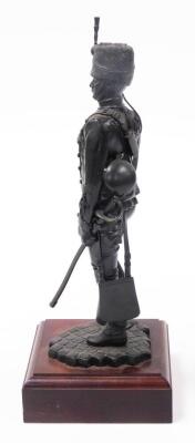 A bronze painted regimental resin figure of a sergeant of 11th Hussars c1890, on a wooden plinth, 36.5cm high. - 2