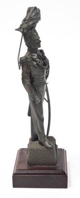 A bronze patinated regimental resin figure of an officer of the 17th/21st Lancers, on a wooden plinth, 42.5cm high, 7cm wide, 6cm deep, the base 4cm high, 13cm wide, 13cm deep. - 4