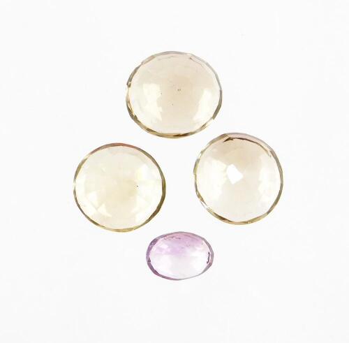 Four loose gemstones, to include round cut citrine, two oval cut smoky quartz and an oval cut amethyst. (4)