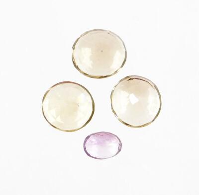 Four loose gemstones, to include round cut citrine, two oval cut smoky quartz and an oval cut amethyst. (4)