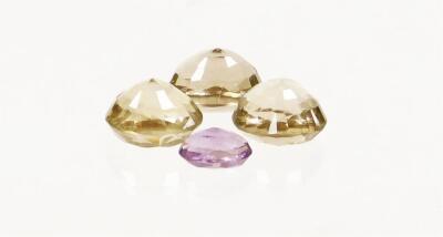 Four loose gemstones, to include round cut citrine, two oval cut smoky quartz and an oval cut amethyst. (4) - 2